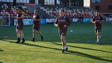 Rugby Players practcing on the pitch 