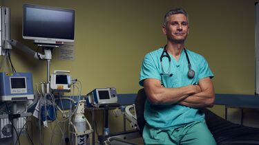 Professor Tim Chico sat in a hospital ward 