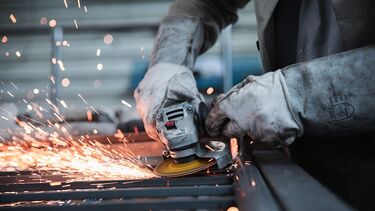 A person soldering.