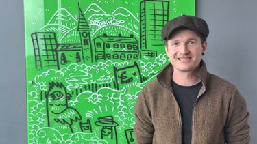 Man posing for photo in front of green screen