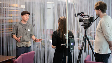 Behind the scenes of man talking to camera