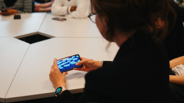 A woman playing a video game on her phone