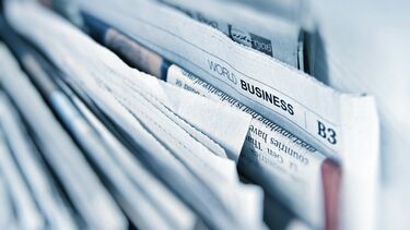 some newspapers in a holder