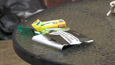 Crumpled tobacco packet and filters on a table