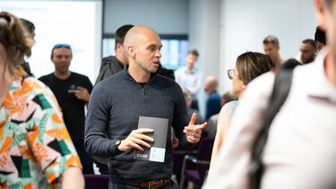 Group of people talking at an event