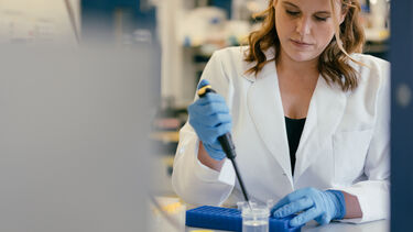 A lab technician working at her desk