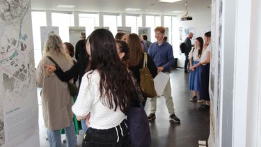 People viewing students design work at the 2024 exhibition in the arts tower