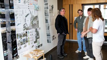 People viewing PGT students design work at the 2024 exhibition in the arts tower