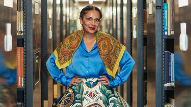 Terezia is wearing a traditional Romani skirt with bookcase to either side. 