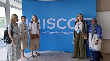 MRG members with IMISCOE banner