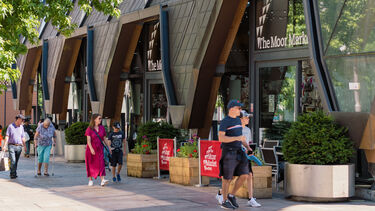 People walking down the street along shop fronts