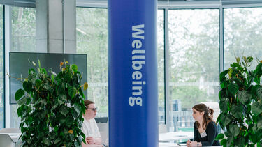 Purple pillar with 'Wellbeing' written on it