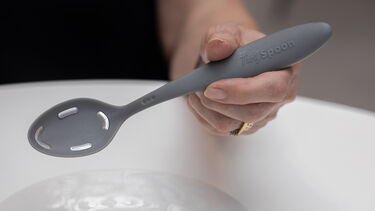 A person holding a Tasty Spoon.