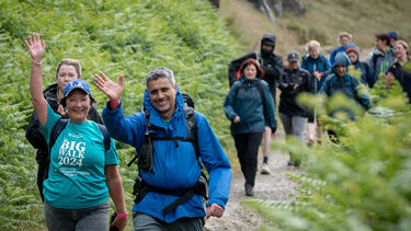 Big Walkers wave at the camera on their way past