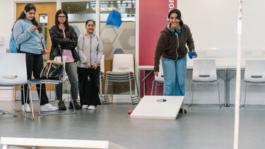Students playing games with bean bags during welcome week at the Management School. 