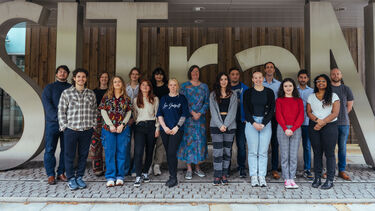 A groups of people standing smiling