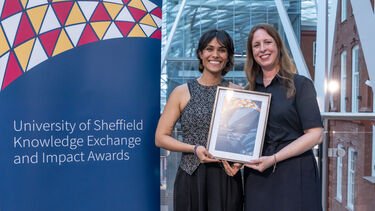 The team posing with their award in the heartspace