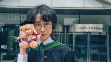 Zhongxiao Hu in a graduation gown