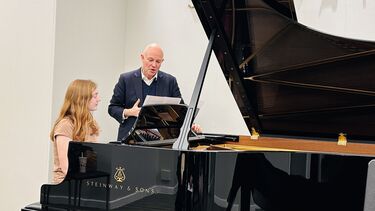 Student at a Steinway Piano in the Steinway showroom