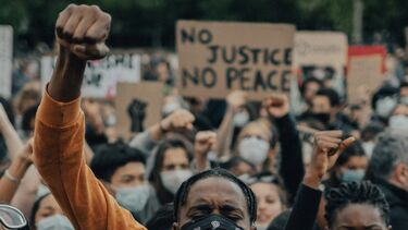 Man raising his fist during a protest for Black Lives Matter in Paris