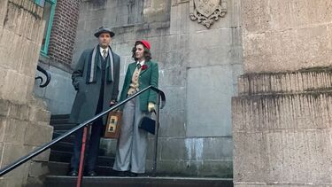 Peter Clements and Lucy Carter from The Nervous State short film stood on steps to a building