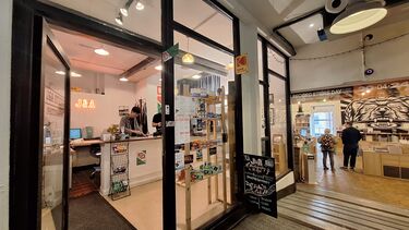 Outside shot of shop and people working inside