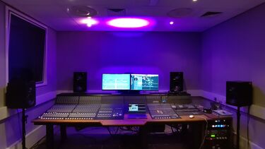 A large mixing console in a recording studio