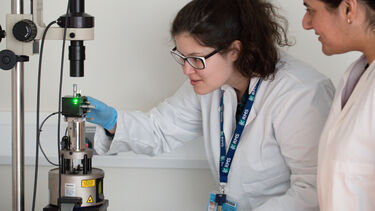 Physics students using equipment