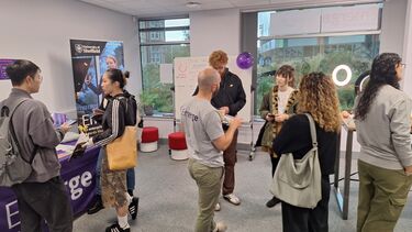 Room of people standing and talking 