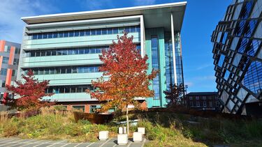 Multi- story building with tree and blue sky