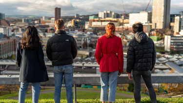 Four students looking over the city of Sheffield