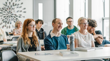 A group of people are listening to a talk