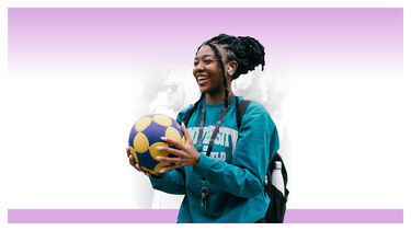 A female student holding a football