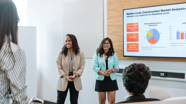 Two MBA students delivering a presentation.