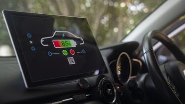 A display on the dashboard of an electric vehicle showing the battery charge level