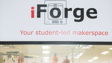 ISAM Conference delegates standing and speaking outside of iForge, The Diamond