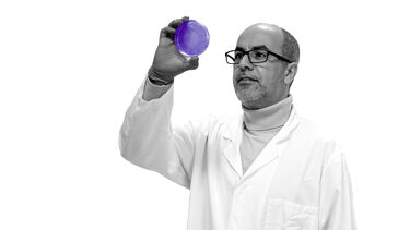 Professor Mimoun Azzouz holding up a petri dish