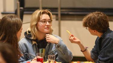 Student sit and chat over food