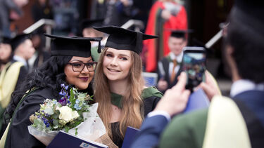 Two female graduates posing for a picture
