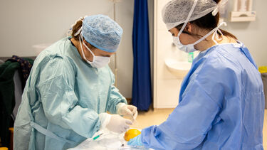 Two trainee ACPs practice their clinical skills