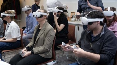 Attendees wear VR headsets to experience symptoms of autism