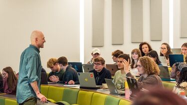 lecturer engaging with students in lecture theatre