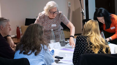 Professor Carolyn Axtell engages with attendees