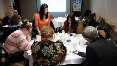 Dr Hui Zhang engages with attendees