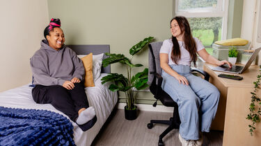 Students in their hall room chatting