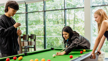 Residents playing a game of pool