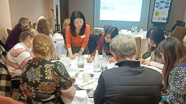 Dr Hui Zhang discusses interactive activity with attendees