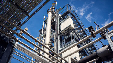 A carbon capture rig featuring a network of intricate pipes across two levels.