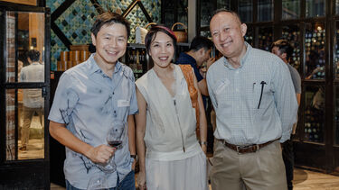 Three Sheffield alumni smiling to the camera at the Singapore alumni event.