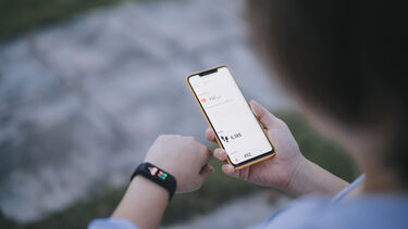 person using smart watch and phone